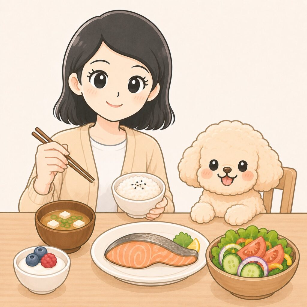 食卓で鮭、ご飯、味噌汁、サラダを前に、笑顔で食事を楽しむよたきちとぴょんたのイラスト